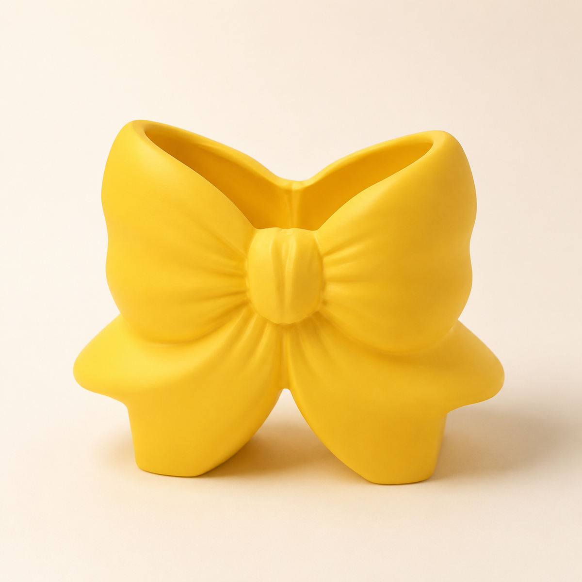 Bow Brush Holder in matte butter yellow, sculpted bow-shaped makeup brush holder